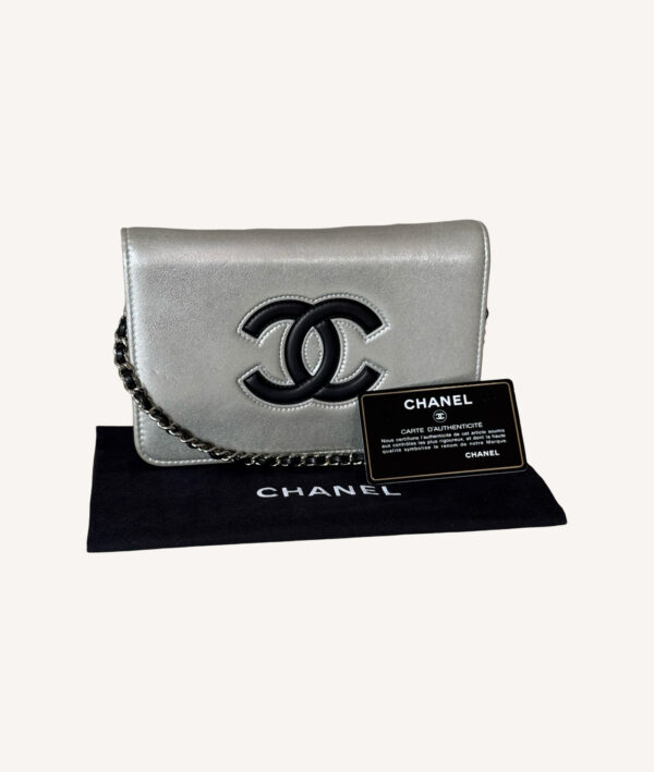 Chanel silver leather WOC with crossbody chain and snap flap closure