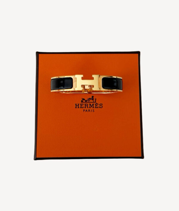 iew of Hermès Le Bracelet Clic H in noir with gold-tone and H clasp